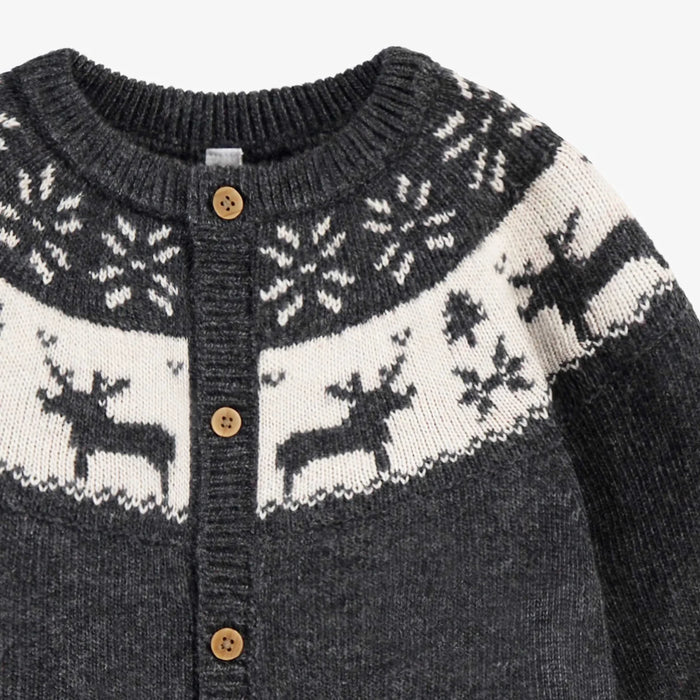 Close-up of a dark gray sweater with white reindeer pattern and wooden buttons on a white background