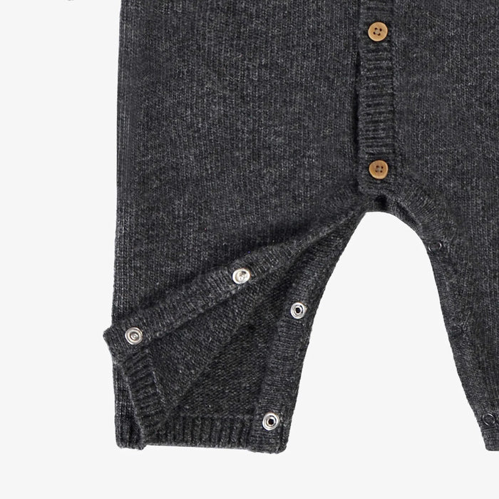 Dark gray baby romper with button details on a white background