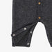 Dark gray baby romper with button details on a white background