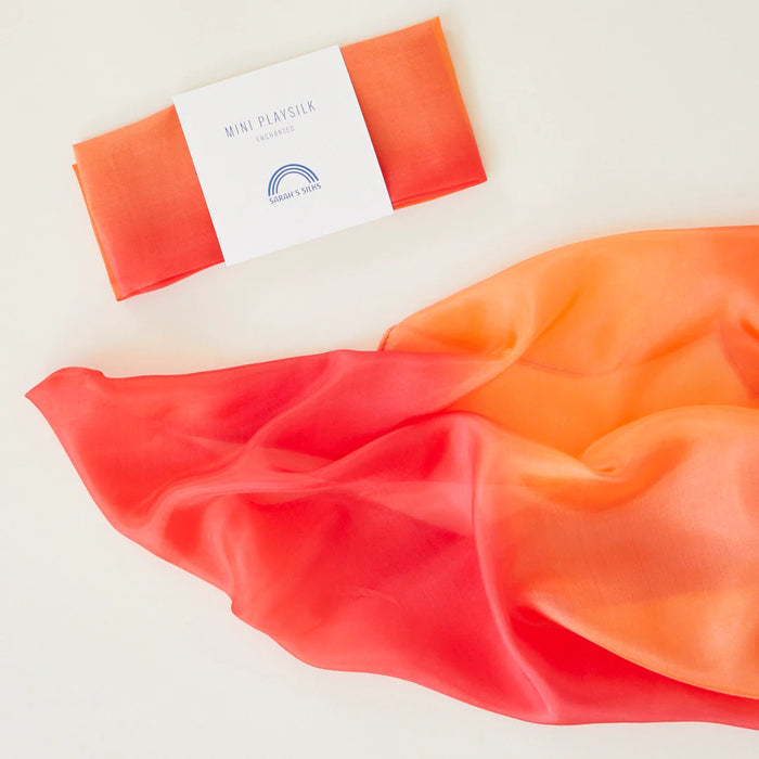 Orange silk square with a label 'Mini Playsilk' on a light background