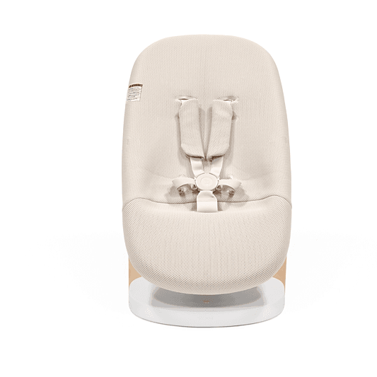 A Stokke Yoga Baby Bouncer & Swing with beige fabric, white frame, and wooden legs against a white background.