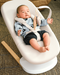 baby lounges in stokke yoga bouncer in a livingroom setting