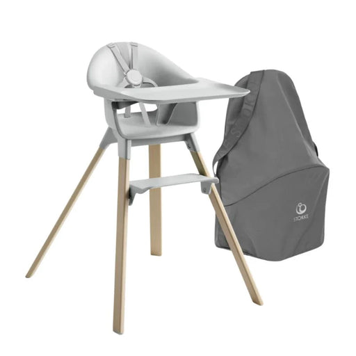 Gray Stokke high chair with tray wooden legs and matching bag on a white background