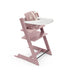 Pink high chair with a white tray on a white background