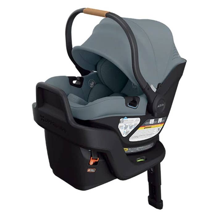 Blue and black baby car seat with canopy on a white background