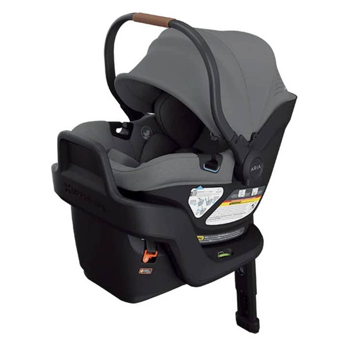Baby car seat with gray cover and black base on a white background