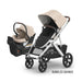 Baby stroller and car seat set with beige canopy on a white background