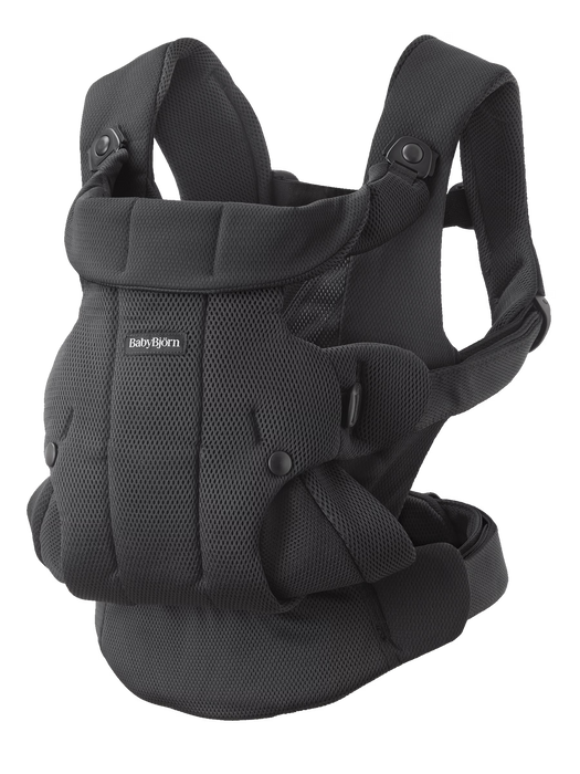 Black mesh baby carrier with buckles on white background with Baby Bjorn logo on front. 