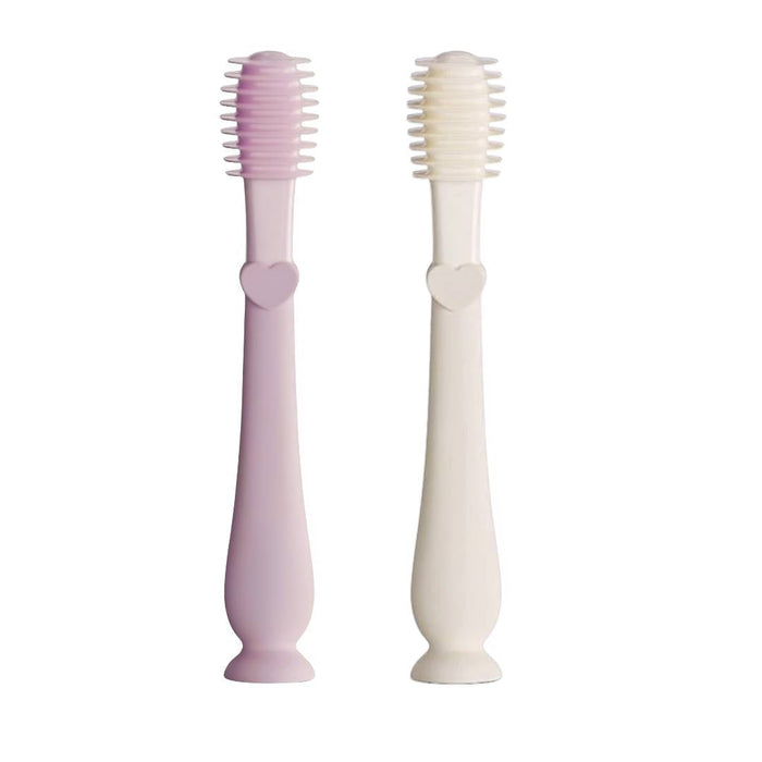 Two children's toothbrushes, one pink and one white, on a white background.