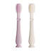 Two children's toothbrushes, one pink and one white, on a white background.