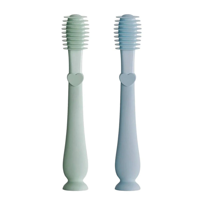 Two light blue silicone brushes with heart designs on a white background