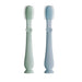 Two light blue silicone brushes with heart designs on a white background