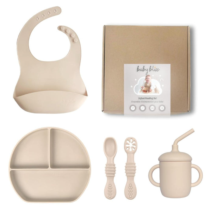 Baby feeding set with bib, plate, cups, and spoons on a white background