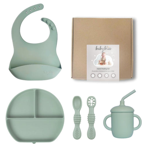 Baby feeding set with bib, plate, cups, and spoons on a white background