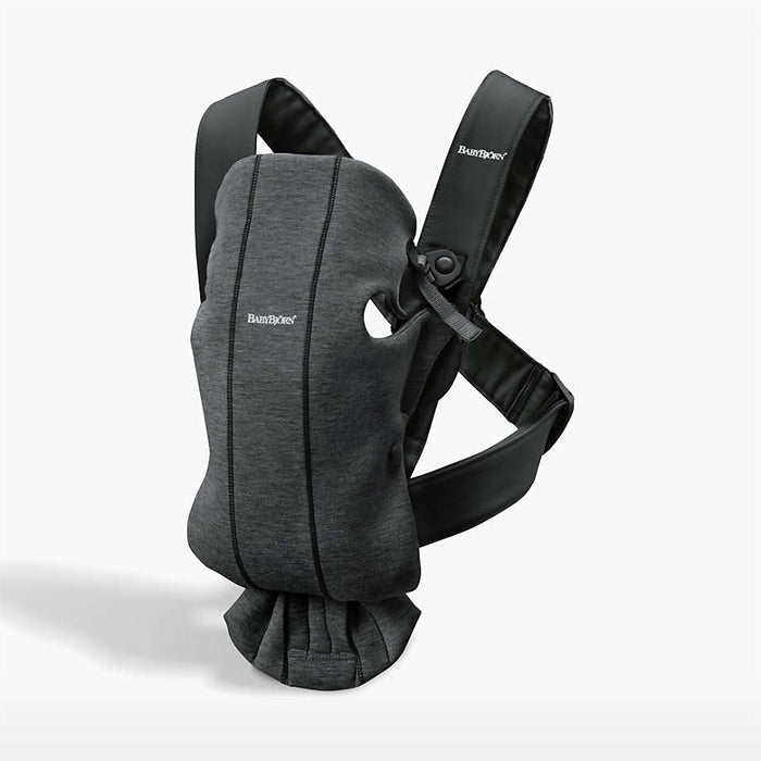 Gray baby carrier with dark straps on a white background