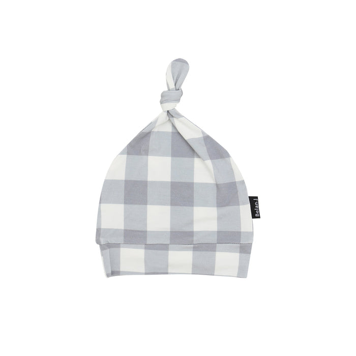 Plaid patterned baby hat with a knot on a white background