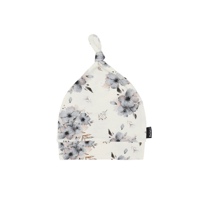 Floral patterned baby hat on a white background