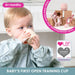 Baby drinking from a training cup with educational toys in the background, featuring LBP certification.
