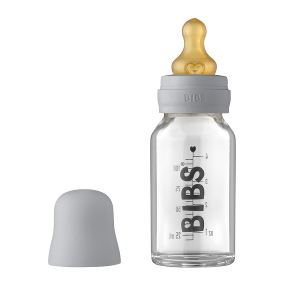 A clear glass baby bottle with a 120ml measurement scale, nipples, and a cap, branded with the name 'BIBS'.