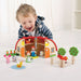 caption-Child plays with Wooden Farm Playlet Barn and Wooden characters
