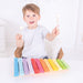 caption-Child holds wooden mallets in front of Snazzy Children's Xylophone