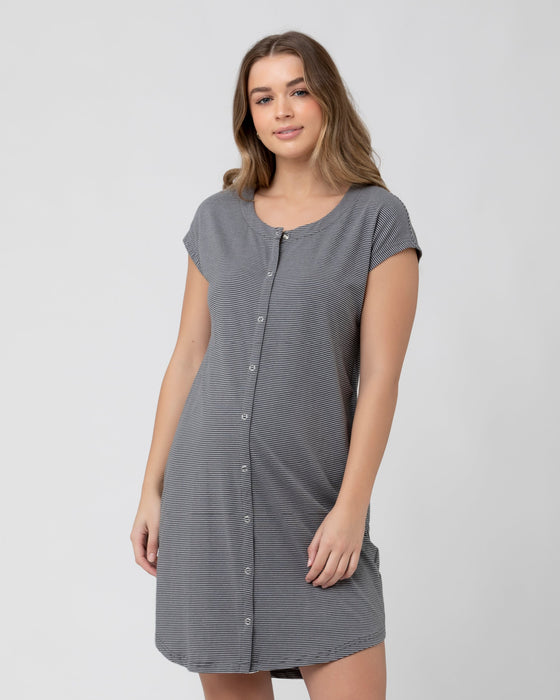 Woman wearing a gray striped nightshirt on a white background