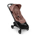 A modern pink Bugaboo stroller shown from a three-quarters angle against a plain white background.