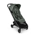 A modern stroller in forest green and black, shown from a three-quarters angle against a plain white background.