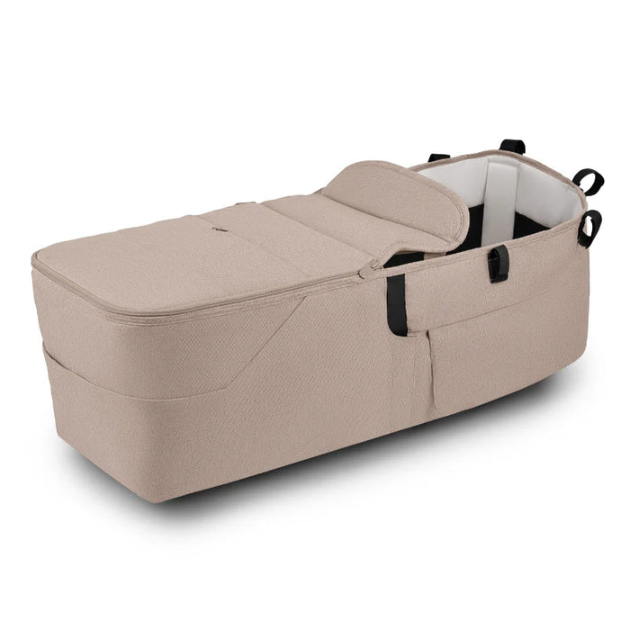 Beige baby bassinet on a white background