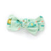 Green bow with frog print on a white background
