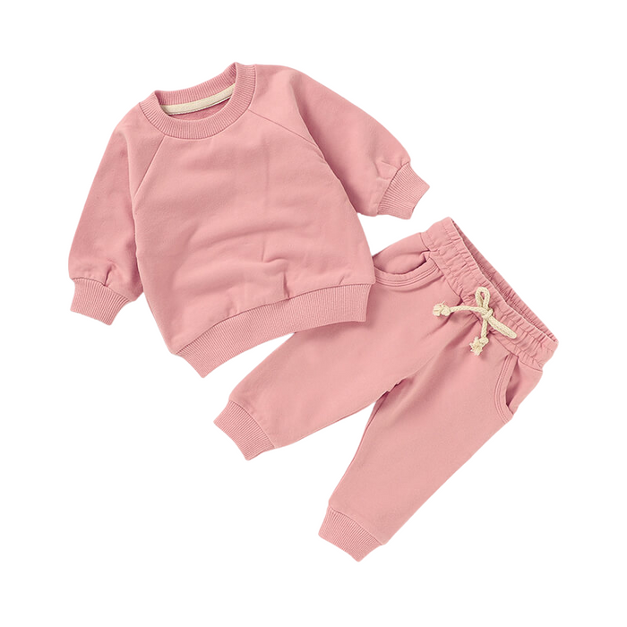 Pink children's sweatshirt and pants set on a white background