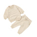 Beige children's sweatshirt and pants set on a white background