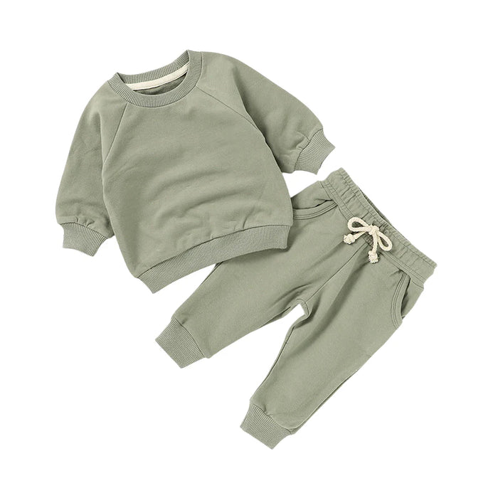 Green children's sweatshirt and pants set on a white background