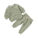 Green children's sweatshirt and pants set on a white background