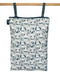 Patterned reusable wet bag with dogs hanging on a wooden rod with a white background