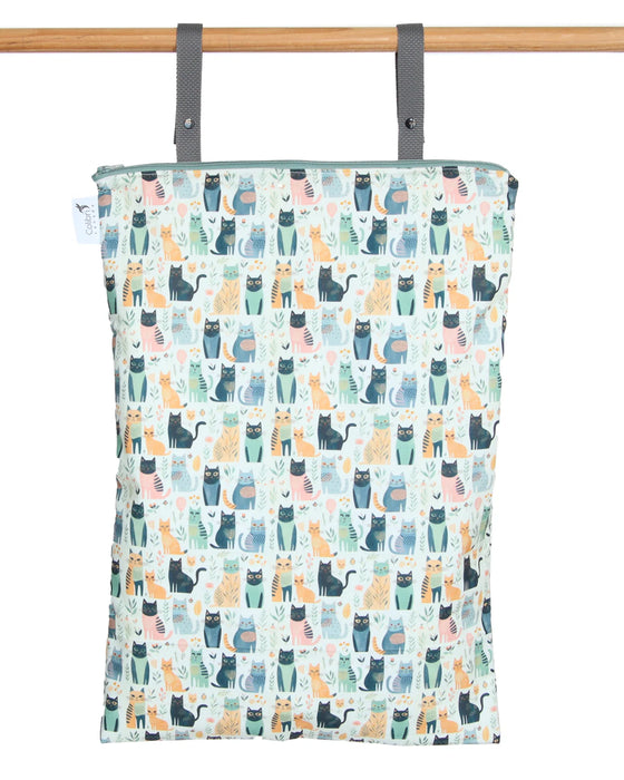 Patterned reusable wet bag with cat design hanging on a wooden rod
