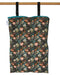 Floral-patterned reusable wet bag hanging on a wooden rod against a white background