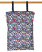 Floral-patterned reusable wet bag hanging on a wooden rod against a white background