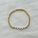 beaded bracelet with MAMA spelled out against a white background