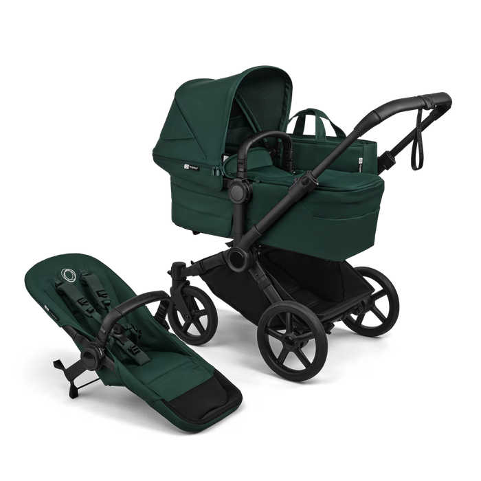 Green baby stroller with attached stroller seat on a white background