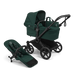 Green baby stroller with attached stroller seat on a white background