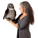 Woman holding a plush owl toy against a white background