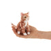 Small orange and white striped cat plush finger puppet held in a hand against a white background