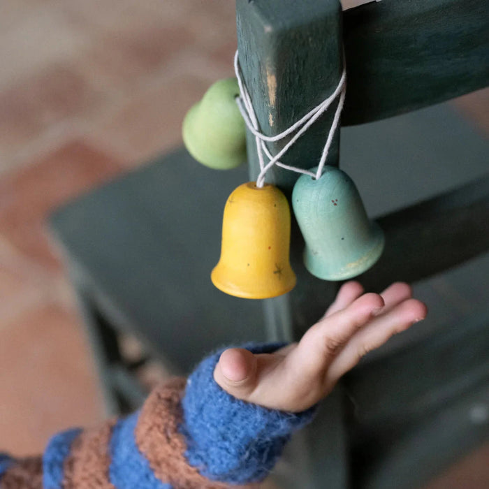 Grapat Wooden Ornament Bell Shaped Decoration with child reaching outstretched hand toward