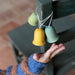 Grapat Wooden Ornament Bell Shaped Decoration with child reaching outstretched hand toward
