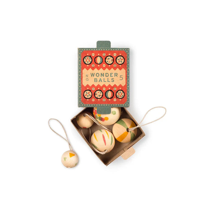 set of 5 wooden christmas ornaments in packaging labelled Wonder Balls No. 5