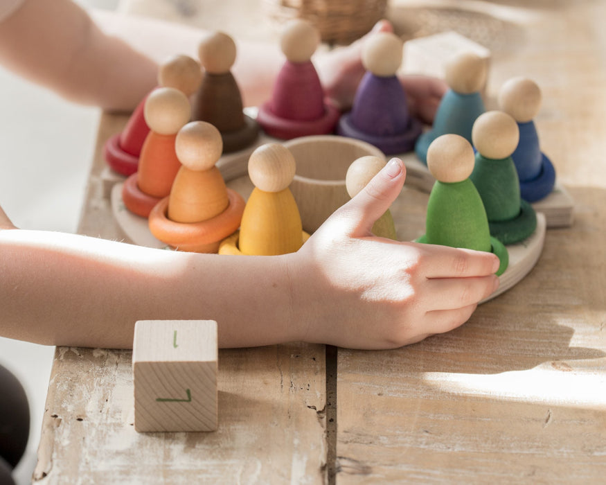 Perpetual Calendar by Grapat in a lifestyle setting on a table with child holding
