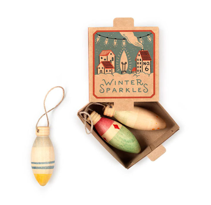 3 Wooden ornaments with 'Winter Sparkles' packaging on a white background