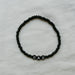 black beaded bracelet with DAD letters on a light background