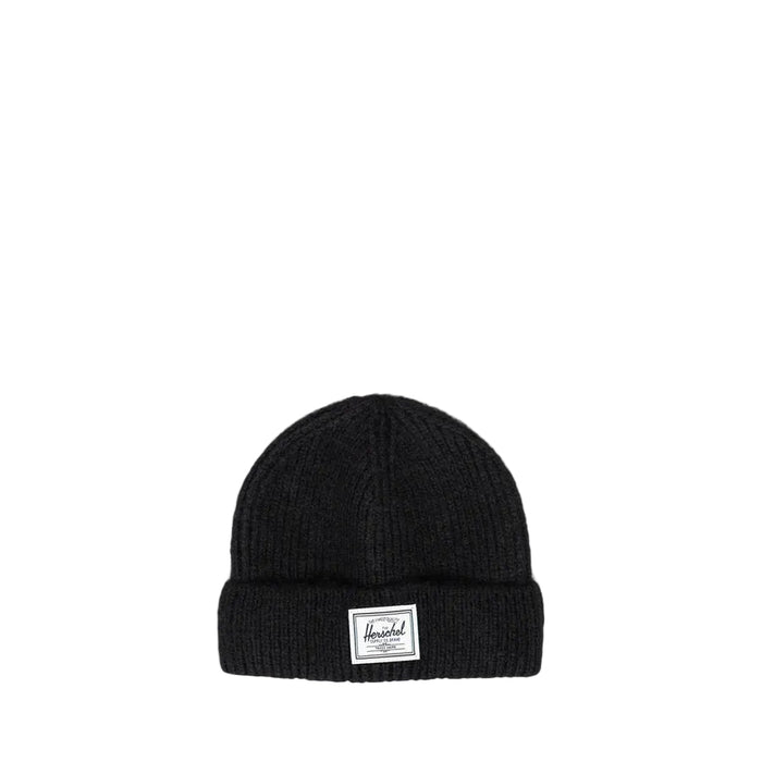 A black ribbed knit beanie hat with a white rectangular brand patch on the front cuff, photographed against a white background.